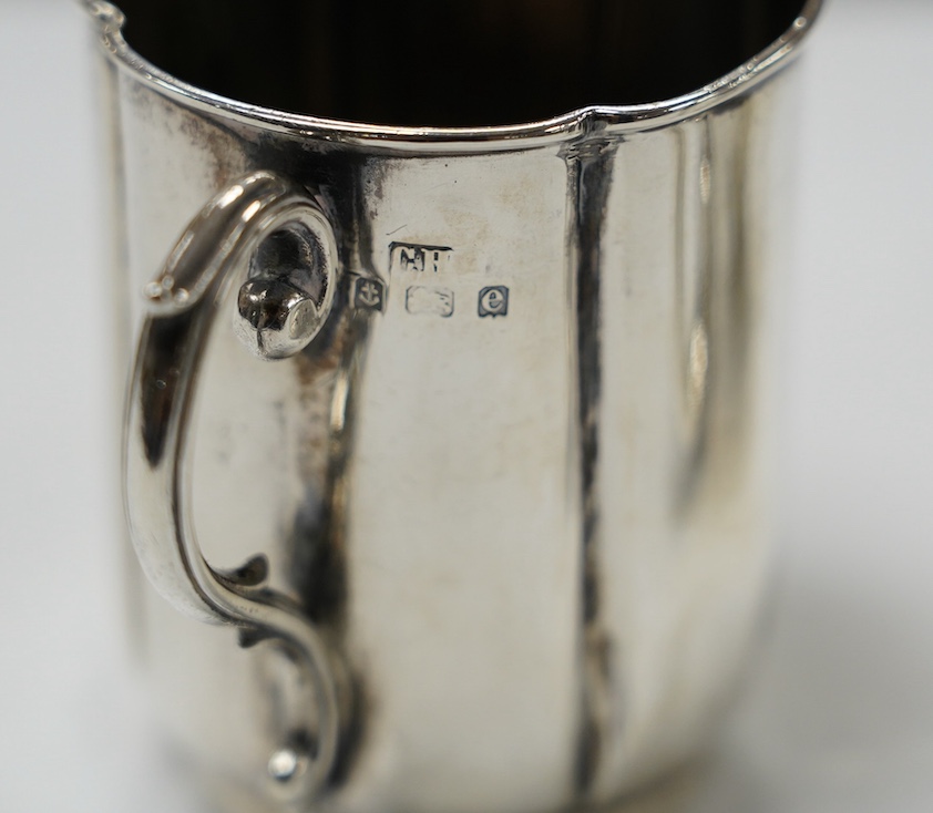 A George V silver mug, by Walker & Hall, Sheffield, 1936, 88mm, together with an earlier silver christening mug, 10.1oz. Condition - fair